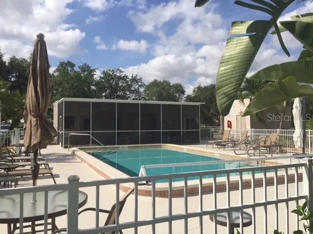 a view of a patio with a table chairs and a fire pit