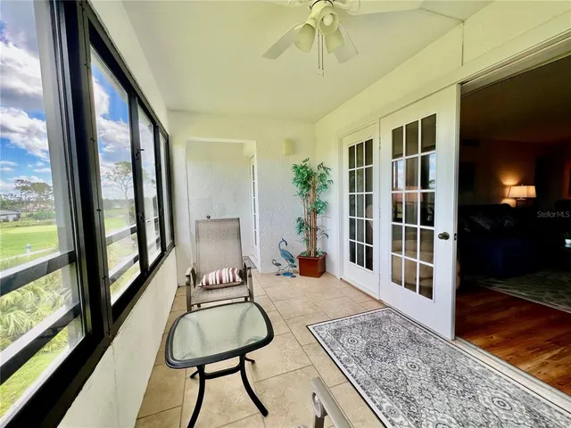 a living room with furniture and a floor to ceiling window