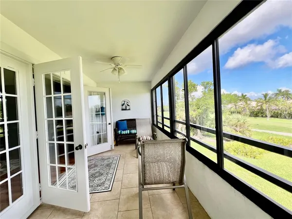 a view of front door and porch with wooden floor