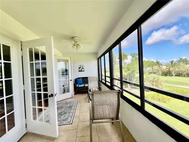 a view of front door and porch with wooden floor