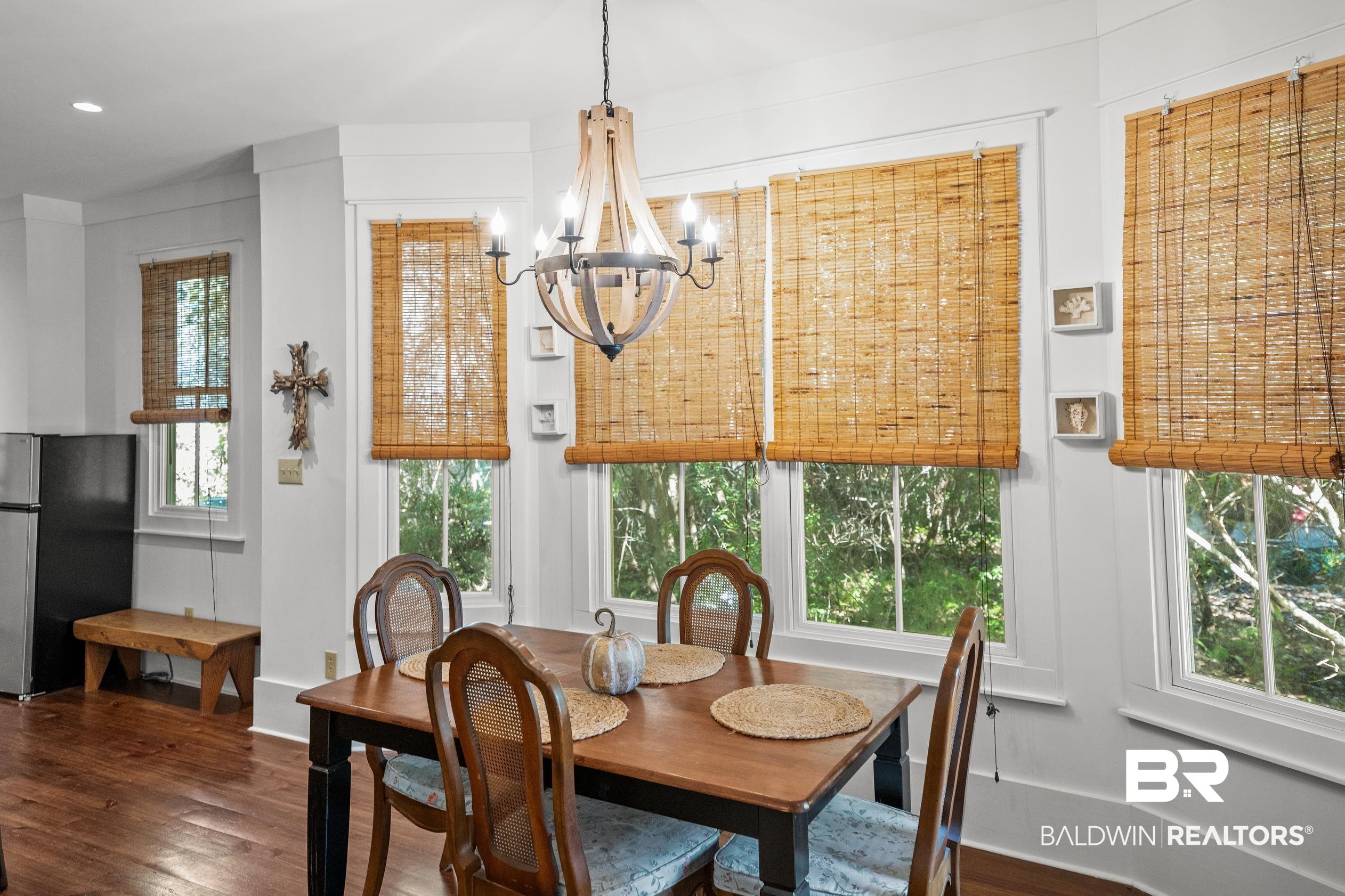 25773 Canal Road, Unit 28 Orange Beach, AL 36561 - Photo 16 of 48 Dining space with dark wood-type flooring and a chandelier