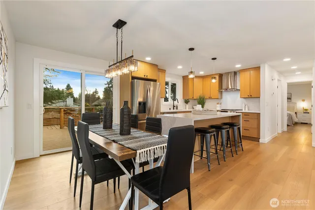 a kitchen with a table chairs microwave and cabinets