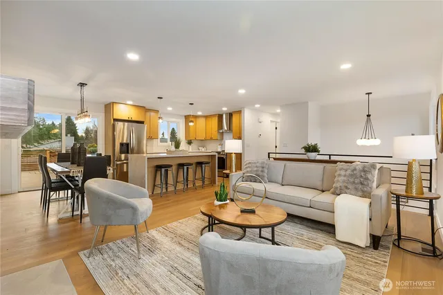 a living room with furniture and kitchen view