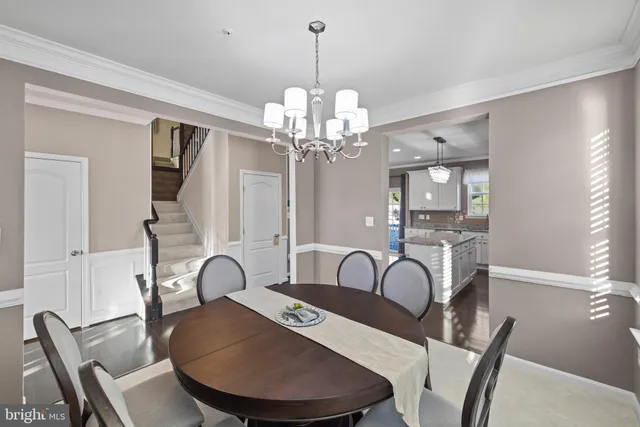 a view of a dining room with furniture and chandelier