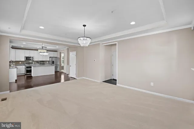 a view of a kitchen with a sink and a refrigerator in it