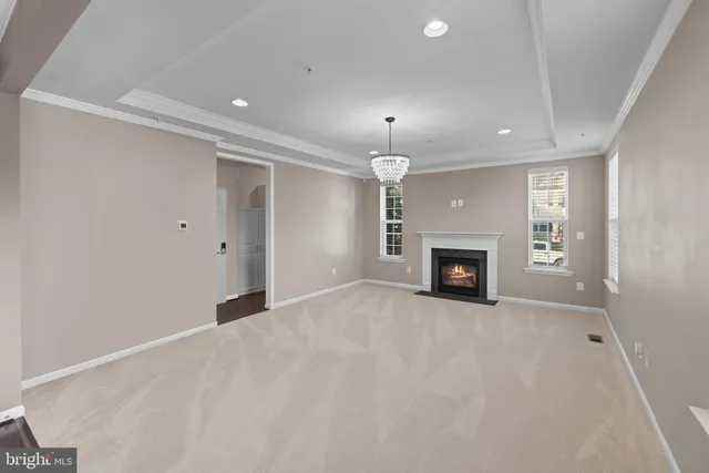 an empty room with a fireplace and window