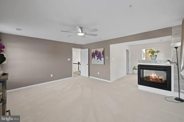 a view of an empty room with a fireplace