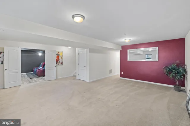 a view of an empty room with potted plants