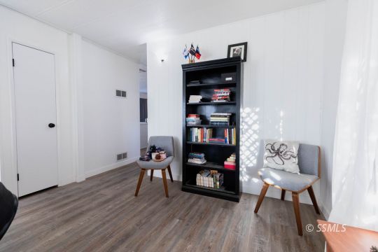 1221 Nocturne Street Ridgecrest, CA 93555 - Photo 10 of 32 a view of a workspace with furniture and wooden floor