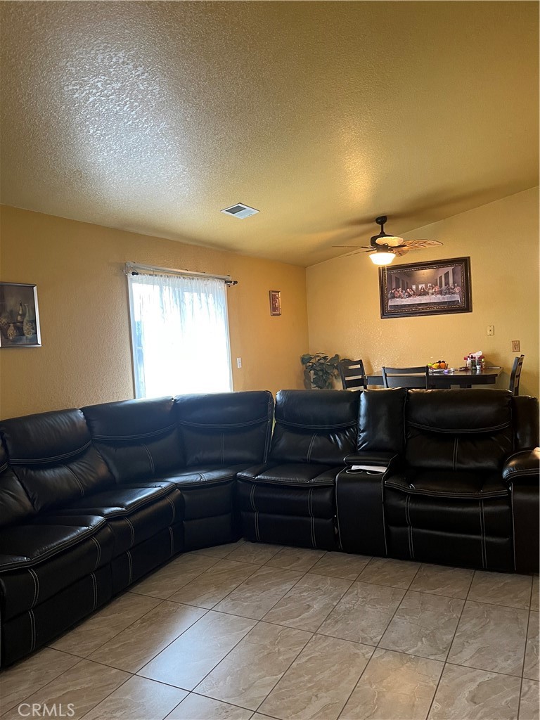 1395 Vine Street Atwater, CA 95301 - Photo 5 of 14 a living room with furniture and a flat screen tv