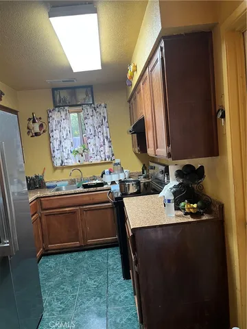 a kitchen with a sink stove and refrigerator