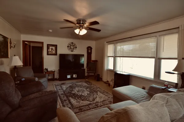 a living room with furniture a window and a flat screen tv
