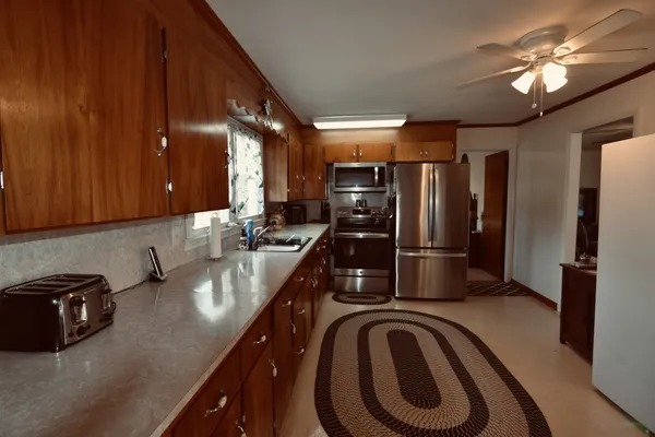 a kitchen with stainless steel appliances a sink a stove and refrigerator
