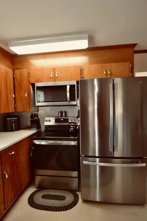 a kitchen with a refrigerator and a stove