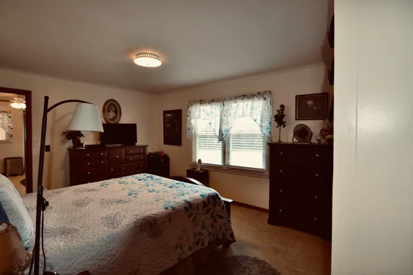 a bed room with a bed and a dresser