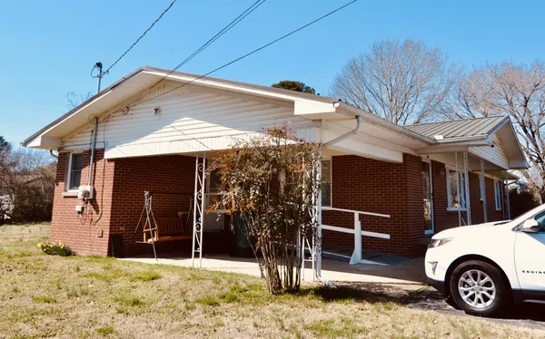 a view of a house with a snow in the yard