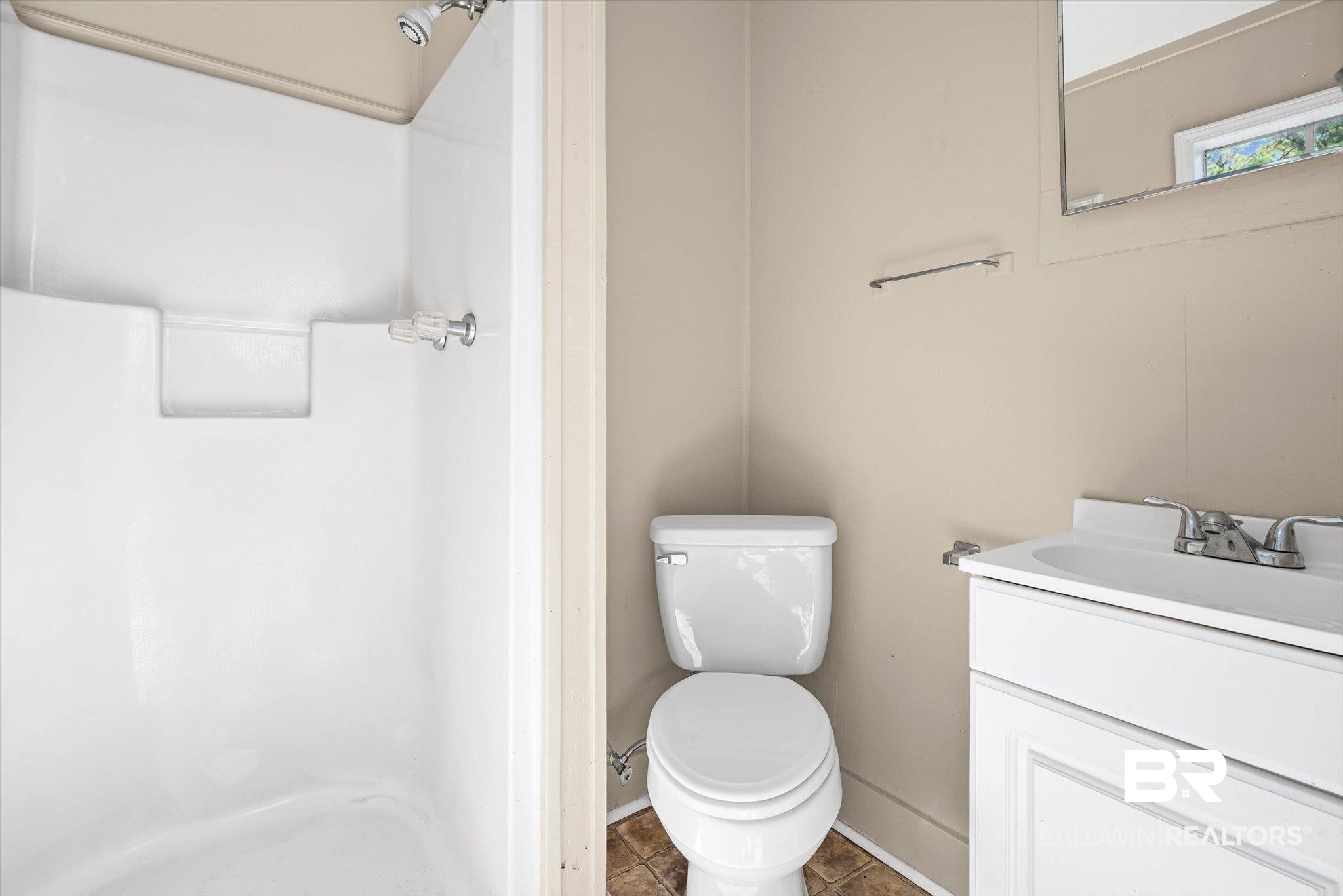 7650 Iron Rush Road Wilmer, AL 36587 - Photo 26 of 34 Bathroom with a stall shower, vanity, and tile patterned floors