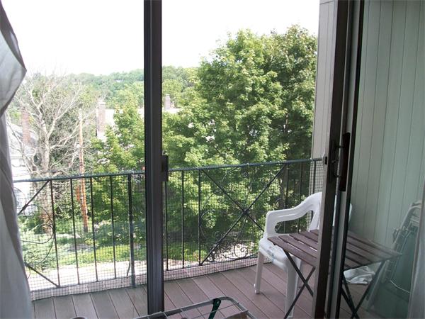 16 Addington Road, Unit 31 Brookline, MA 02445 - Photo 1 of 1 a view of a chair and tables in the balcony