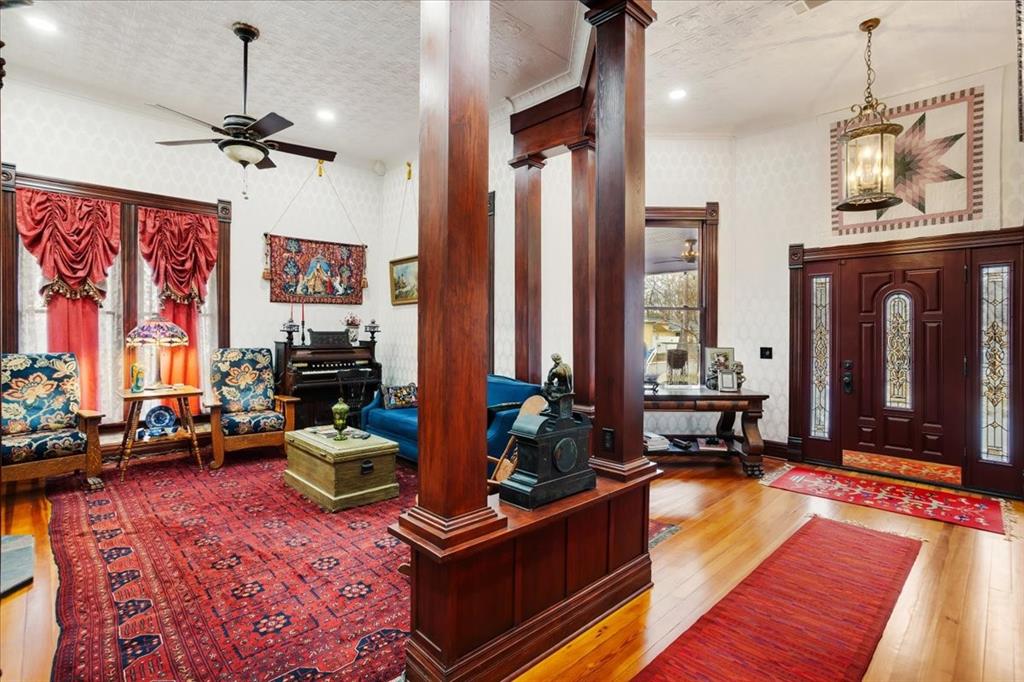300 West 6th Street Bonham, TX 75418 - Photo 2 of 37 a living room with furniture a rug and a chandelier