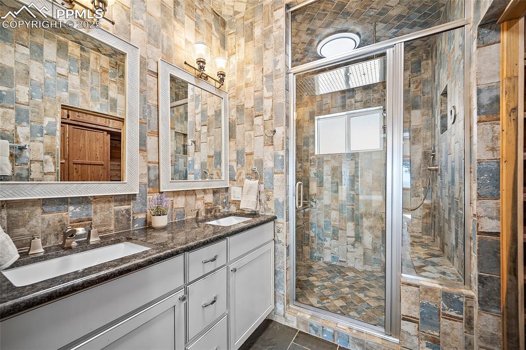 10739 Arnold Lane Rye, CO 81069 - Photo 14 of 50 a bathroom with a granite countertop sink a mirror and shower