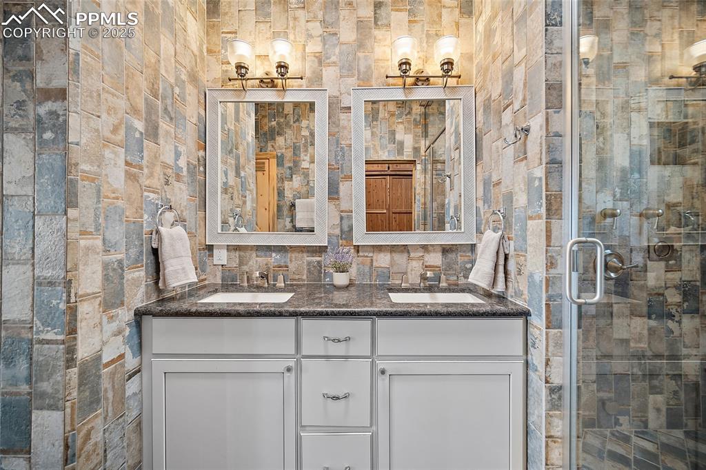 10739 Arnold Lane Rye, CO 81069 - Photo 15 of 50 a bathroom with a granite countertop shower sink and mirror