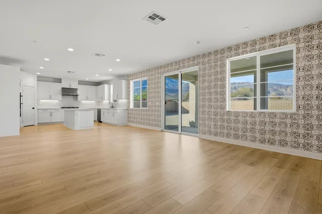 a view of an empty room with a kitchen