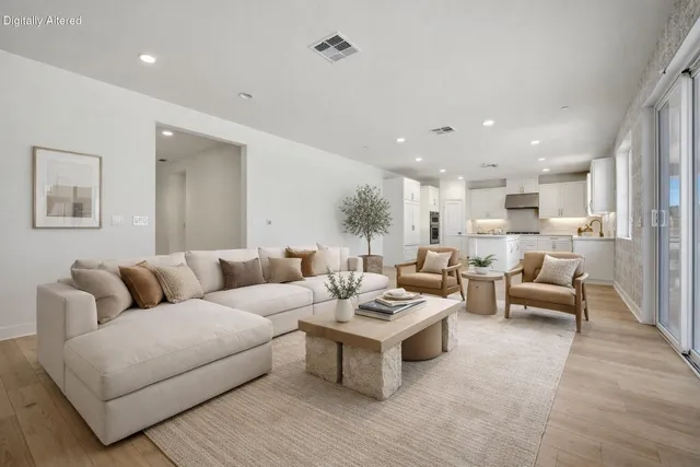 a living room with furniture and view of kitchen