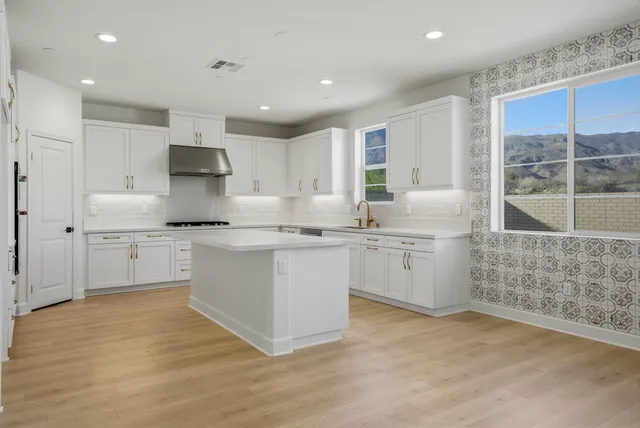 a kitchen with white cabinets and white appliances