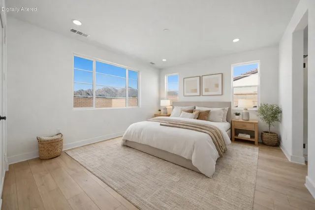 a bedroom with a bed and a large window