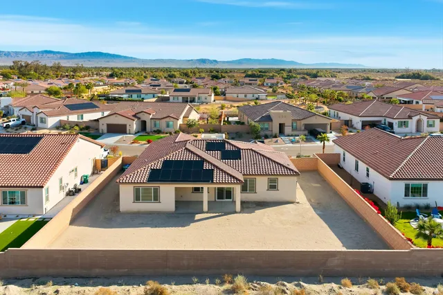 an aerial view of residential houses with city view