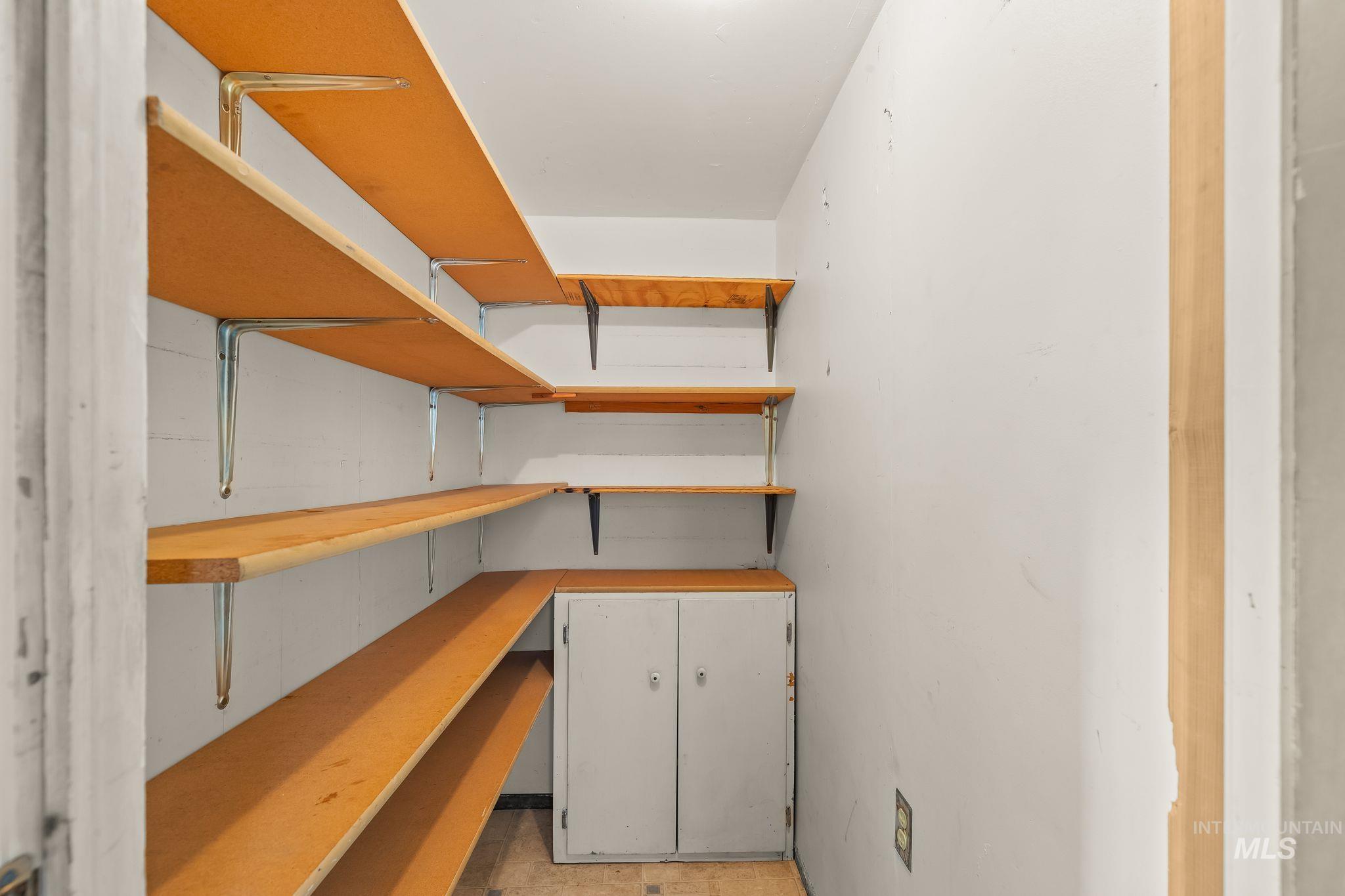 1721 3rd Street Lewiston, ID 83501 - Photo 27 of 45 Compact pantry with extensive wood-finish shelving and a built-in lower cabinet