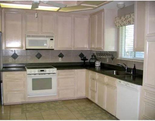 a kitchen with stainless steel appliances granite countertop a sink a stove and a granite counter tops