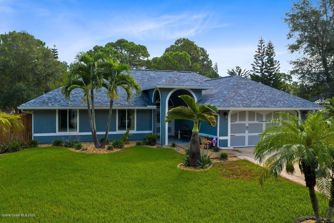 689 Bryant Road Palm Bay, FL 32908 - Photo 1 of 27 a view of a house with a yard potted plants and a table