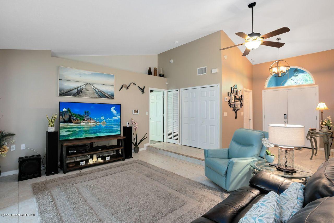 689 Bryant Road Palm Bay, FL 32908 - Photo 14 of 27 a living room with furniture and a flat screen tv