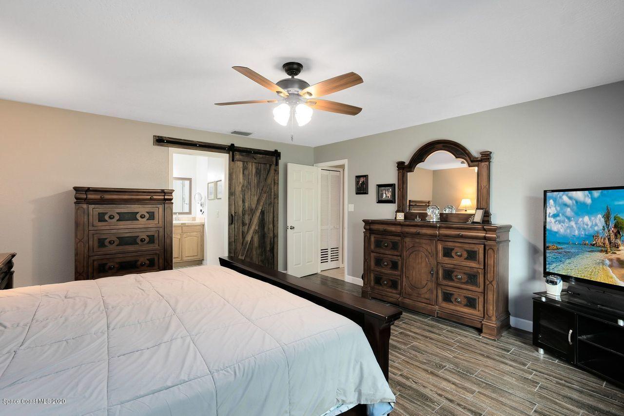 689 Bryant Road Palm Bay, FL 32908 - Photo 16 of 27 a bedroom with a bed and a flat screen tv