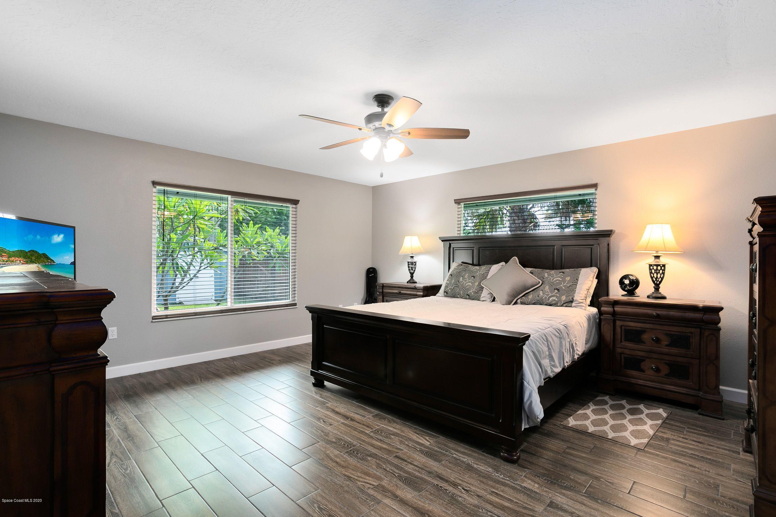 689 Bryant Road Palm Bay, FL 32908 - Photo 17 of 27 a spacious bedroom with a bed and a window