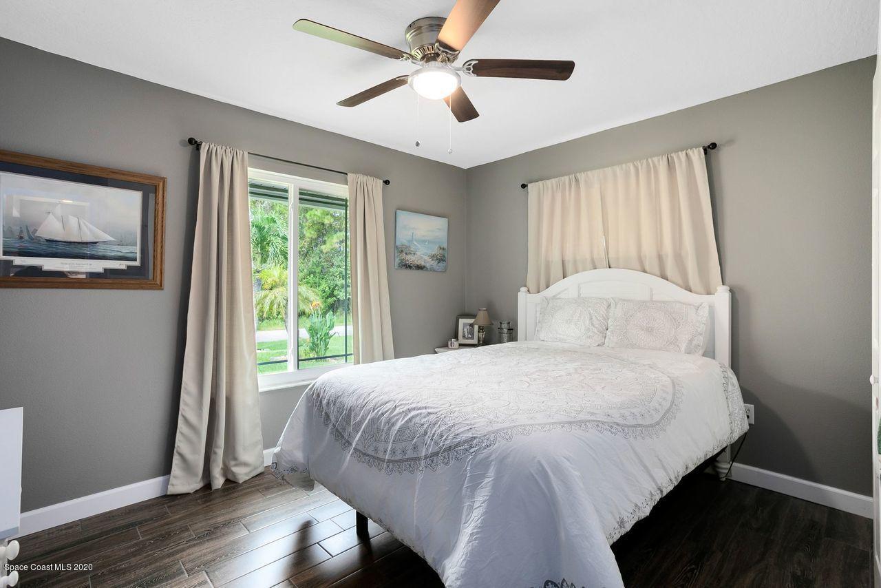 689 Bryant Road Palm Bay, FL 32908 - Photo 19 of 27 a bedroom with a bed and a window