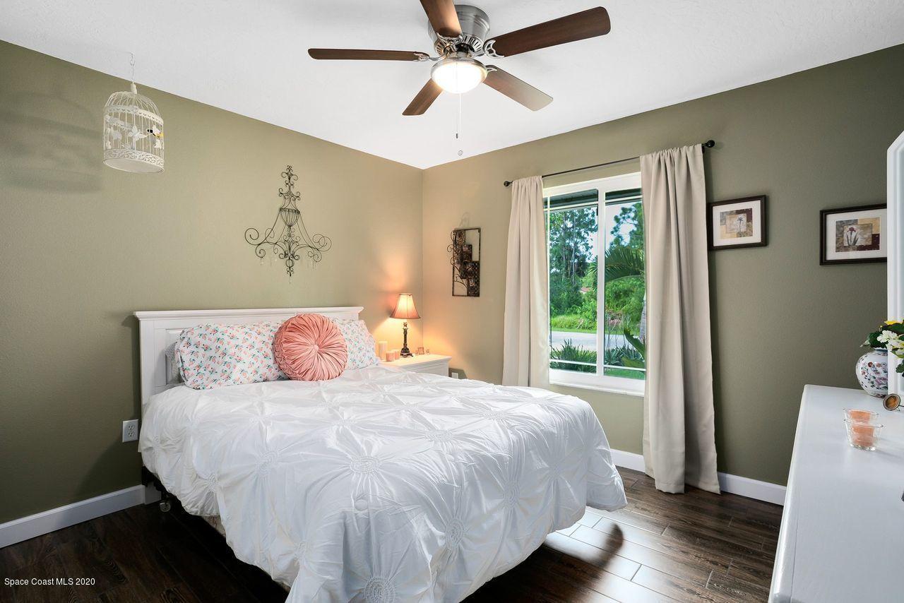 689 Bryant Road Palm Bay, FL 32908 - Photo 20 of 27 a large bed sitting in a bedroom next to a window