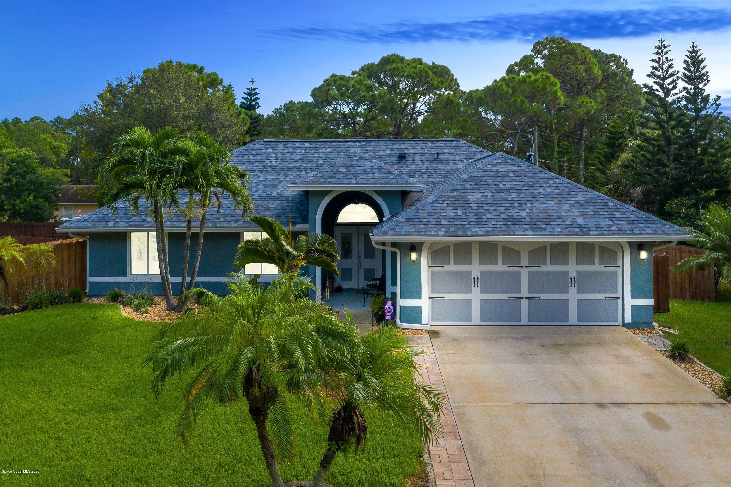 689 Bryant Road Palm Bay, FL 32908 - Photo 3 of 27 a front view of a house with garden