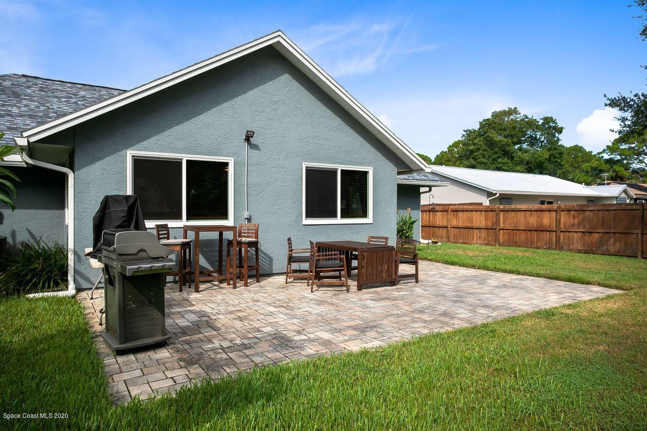 689 Bryant Road Palm Bay, FL 32908 - Photo 23 of 27 a backyard of a house with table and chairs