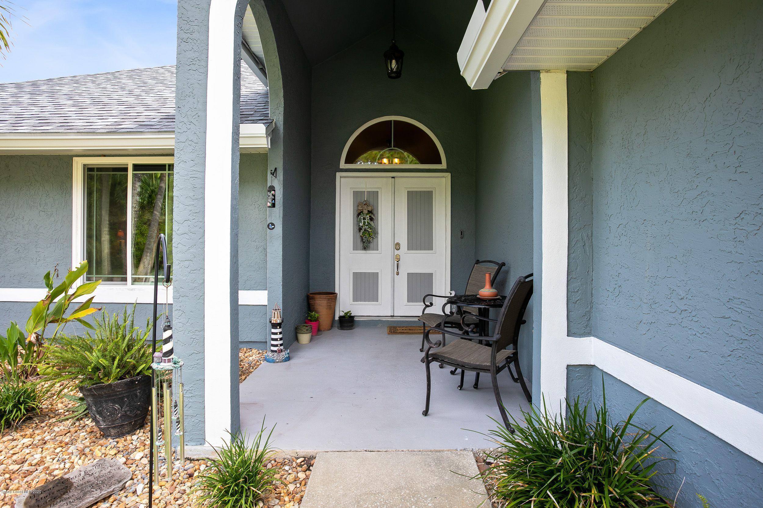 689 Bryant Road Palm Bay, FL 32908 - Photo 4 of 27 a front view of a house with outdoor seating
