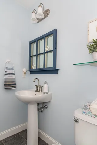 a bathroom with a sink a mirror and a toilet