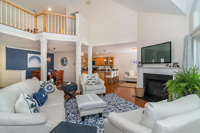 a living room with furniture a fireplace and a flat screen tv