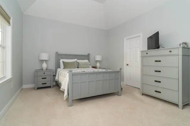 a room with a bed and flat screen tv