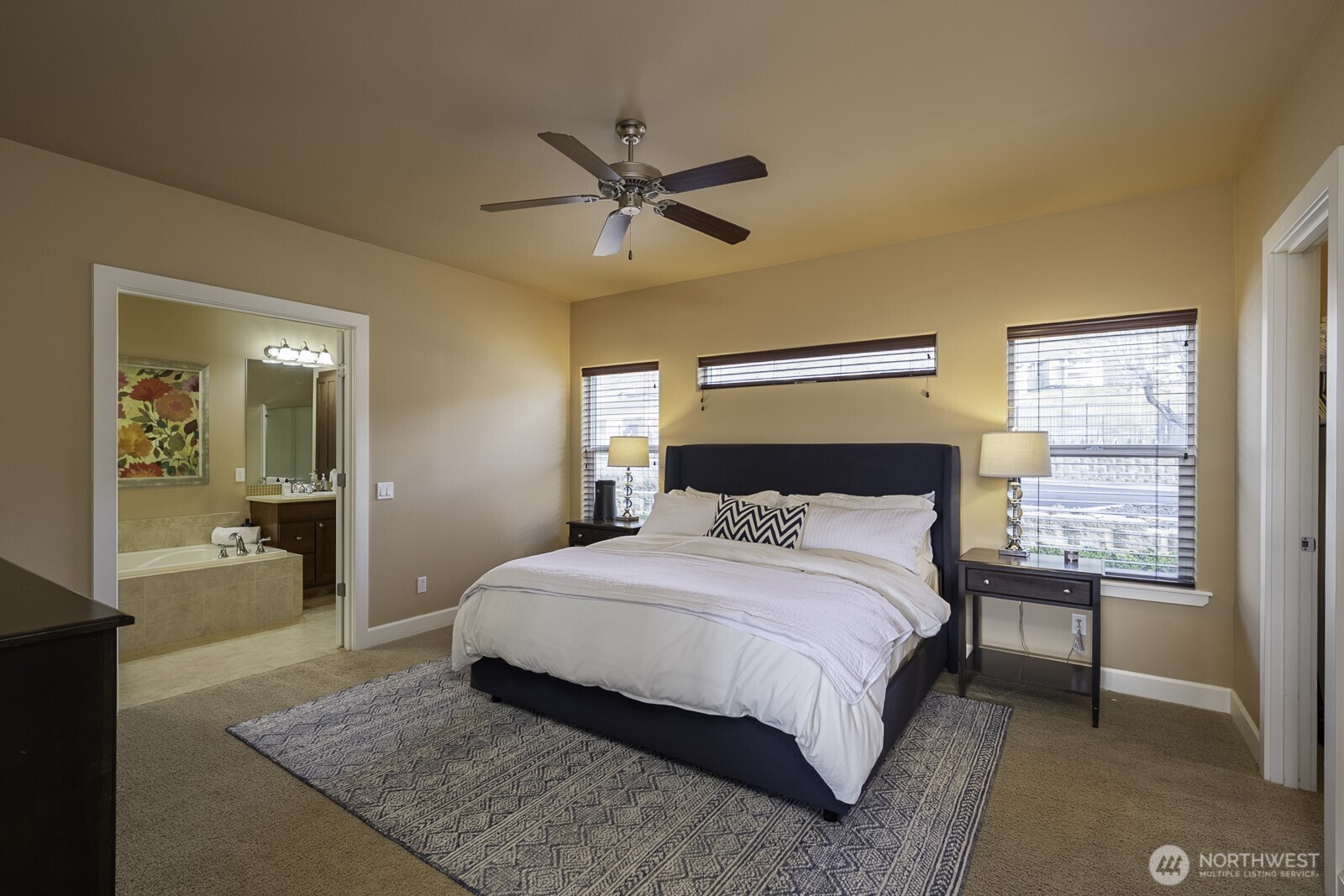 23466 Sunserra Loop Quincy, WA 98848 - Photo 20 of 40 a bedroom with a large bed and a chandelier