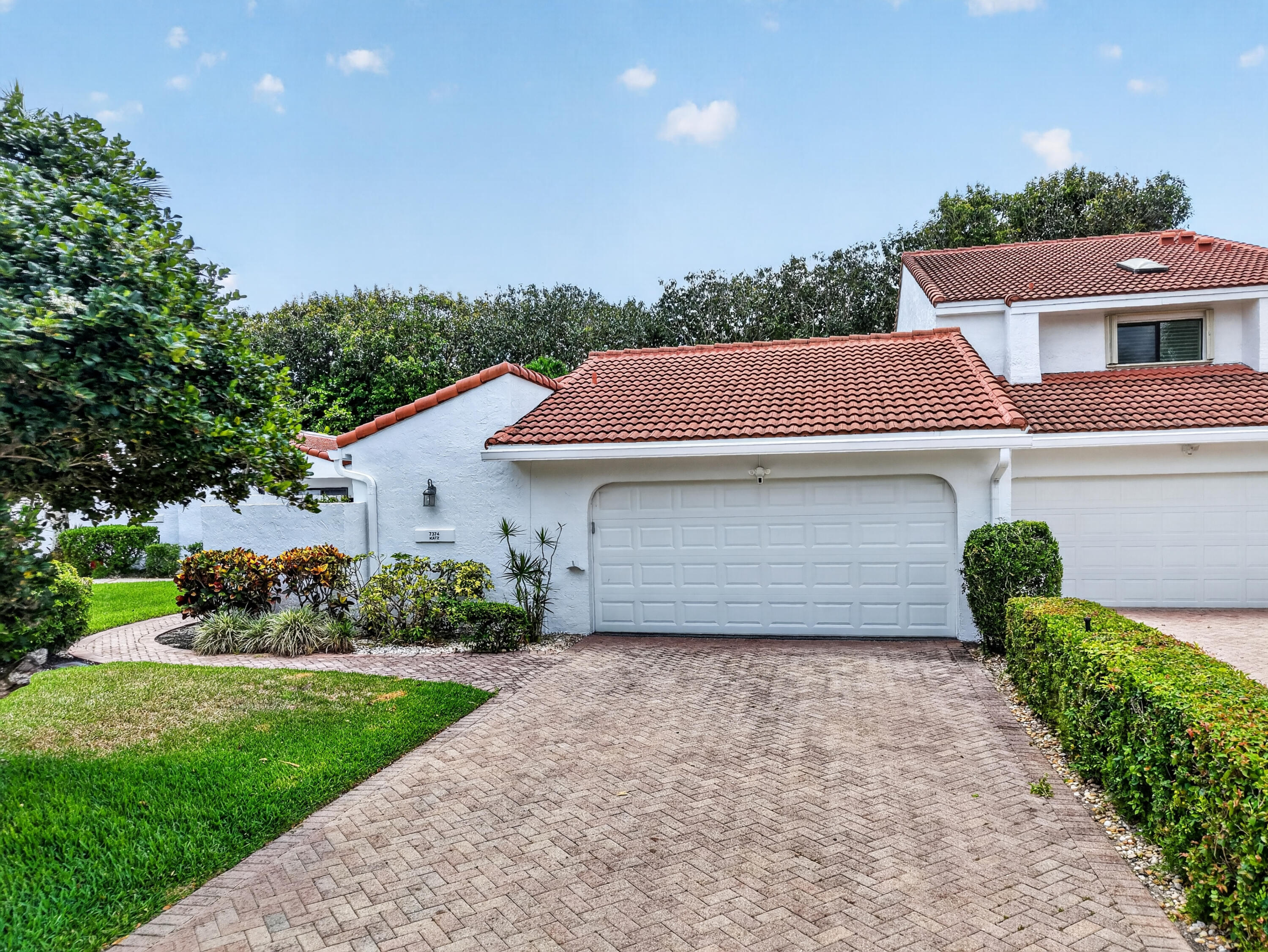 7374 Woodmont Court Boca Raton, FL 33434 - Photo 46 of 95 front view of a house with a yard