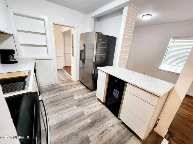 a kitchen with stainless steel appliances a refrigerator sink and microwave