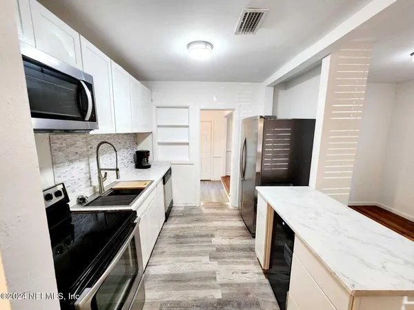 a kitchen with a sink a stove and refrigerator