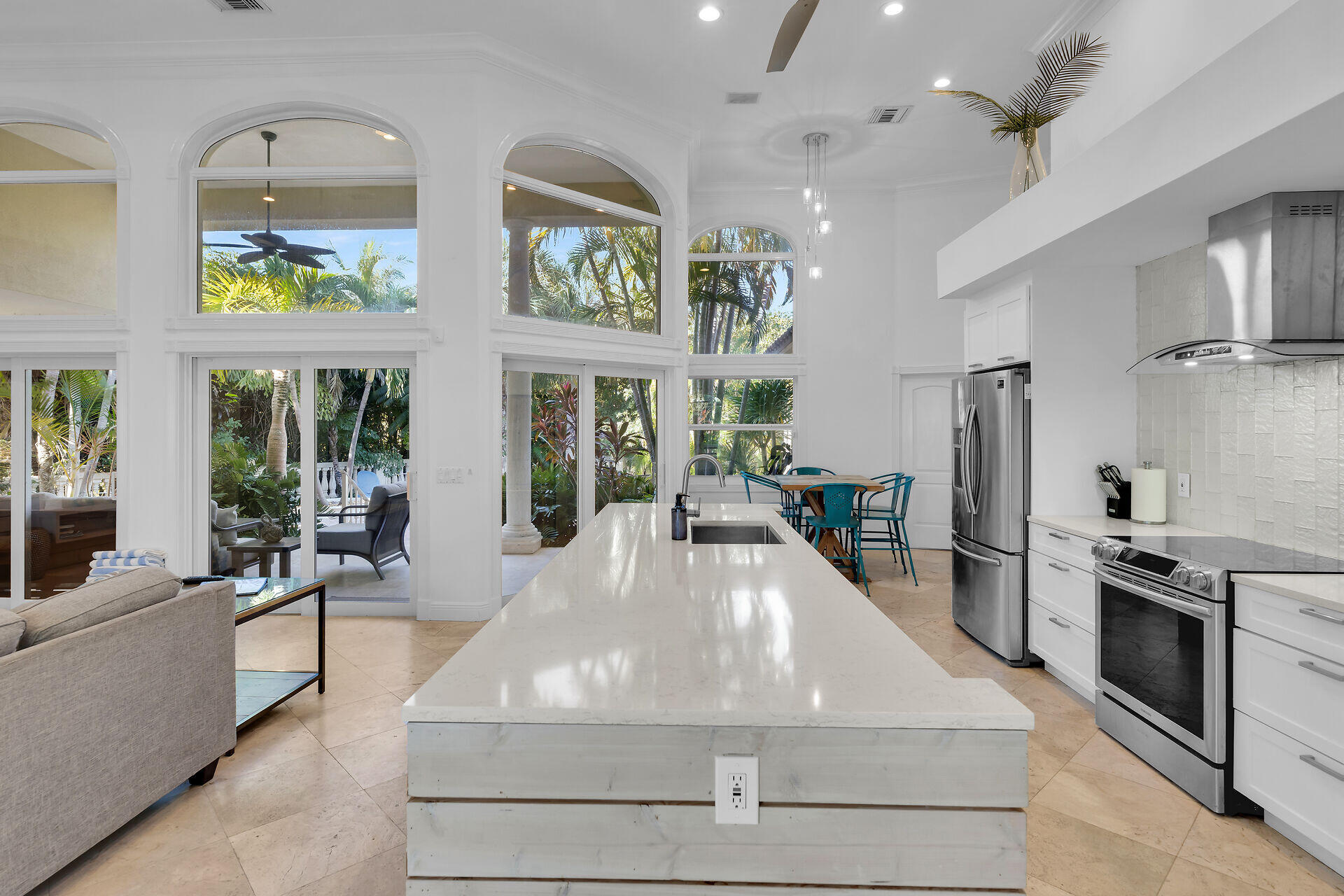 125 13th Street Key Colony Beach, FL 33051 - Photo 12 of 56 a large white kitchen with stainless steel appliances granite countertop a stove and a refrigerator