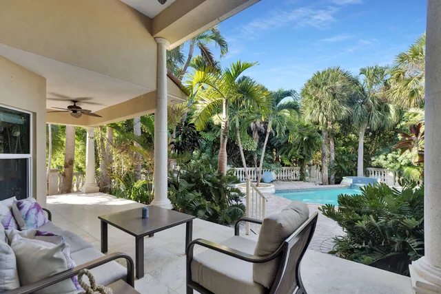 a view of a patio with table and chairs and potted plants